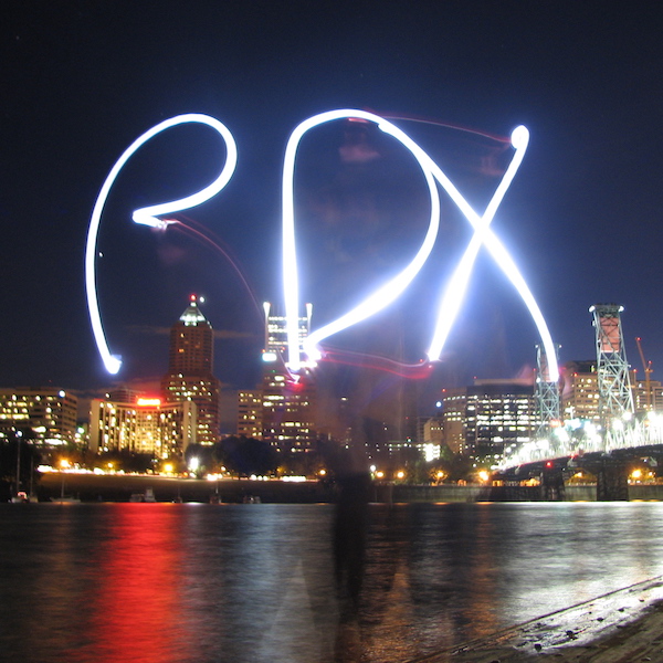 PDX light-writing against downtown Portland skyline